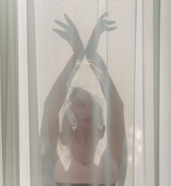 Calm woman in a gentle stretching pose representing Wefequvi.